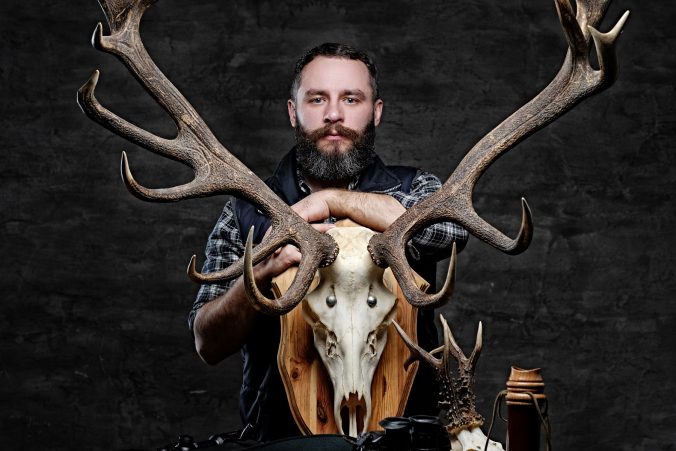 bearded-hunter-in-a-fleece-shirt-with-his-trophies